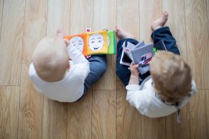 two toddlers reading