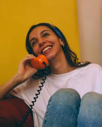 Smiling woman chatting on the telephone