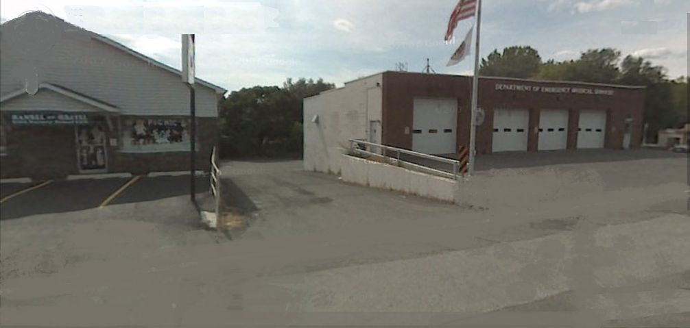 Building and fire station with driveway in between them