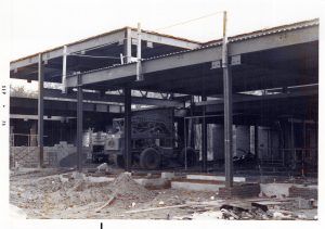 Construction of building with steel beams and machinery